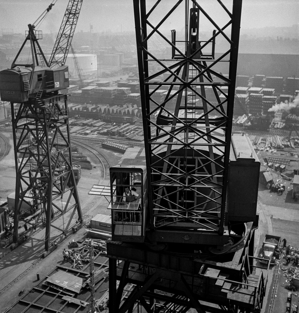 Bethlehem-Fairfield shipyards, Baltimore, Maryland. A crane operator high above the yard