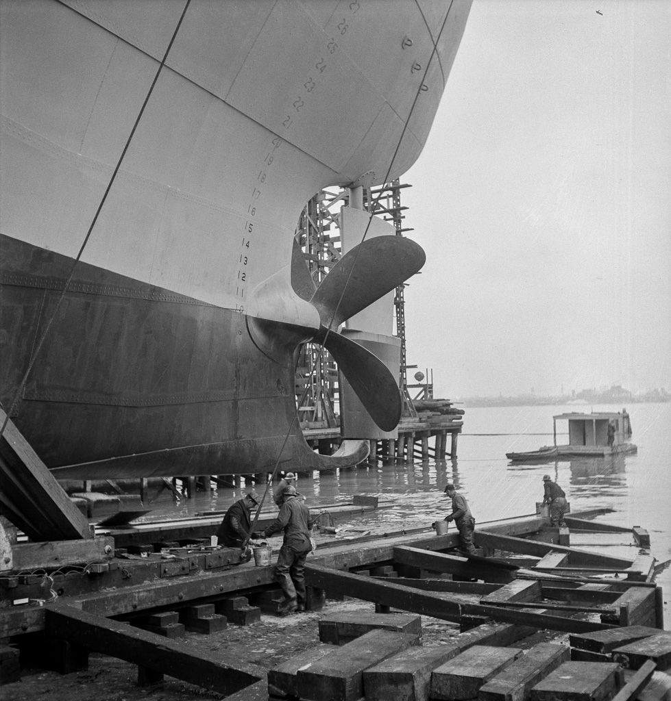 Bethlehem-Fairfield shipyards, Baltimore, Maryland. Greasing outboard end of the ways just before a launching