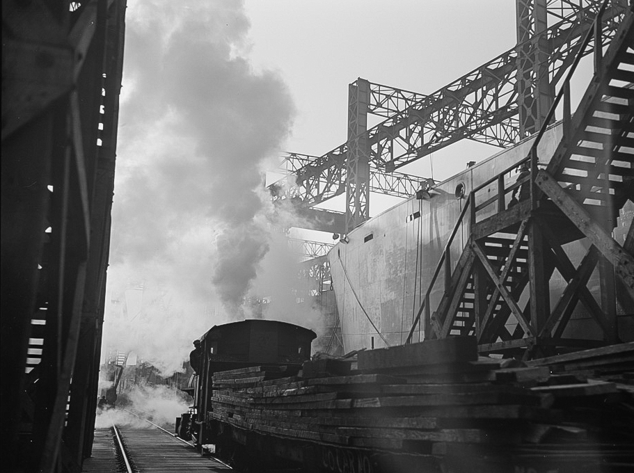Between the ways of this large Eastern shipyard run tracks for flat cars carrying materials or sections to be hoisted onto the decks of ships under construction 2-2