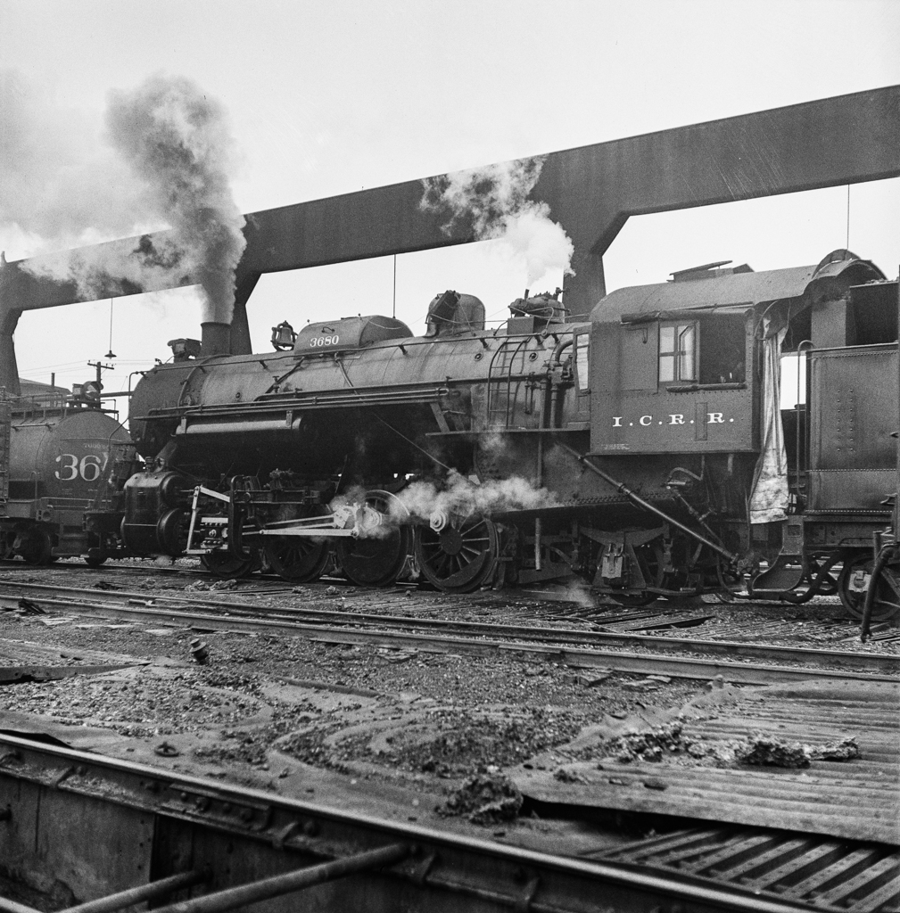 Chicago, Illinois. Locomotive taking on sand at an Illinois Central Railroad yard, before going out on the road