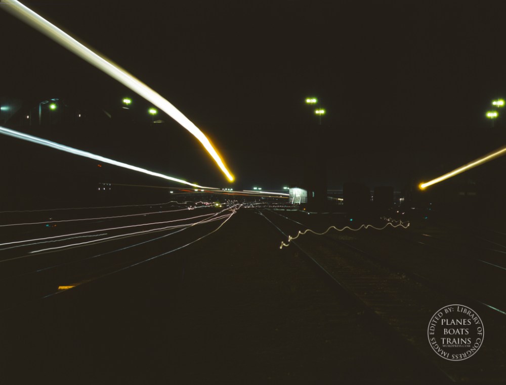 Activity in the Santa Fe R.R. yard, Los Angeles, Calif. All switch lights, head lights and lamps have been shaded from above in accordance with blackout regulations. The heavy light streaks are caused by paths of locomotive headlights and the thin lines by lamps of switchmen working in the yard. Santa Fe R.R. trip